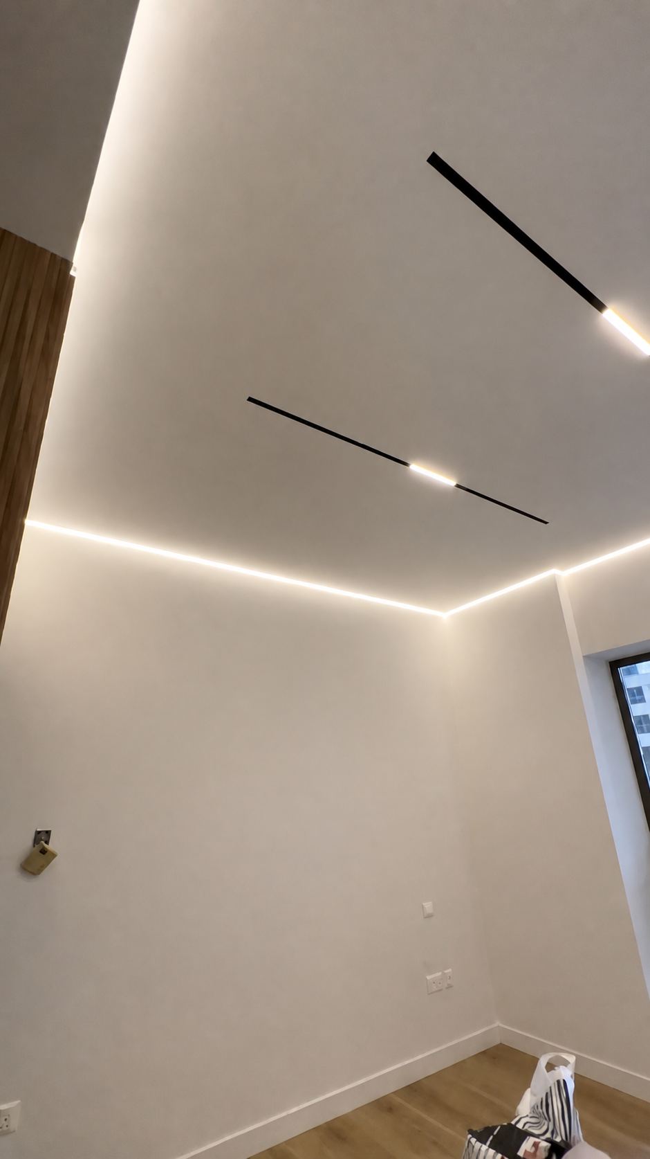The perimeter channel paired with recessed light lines