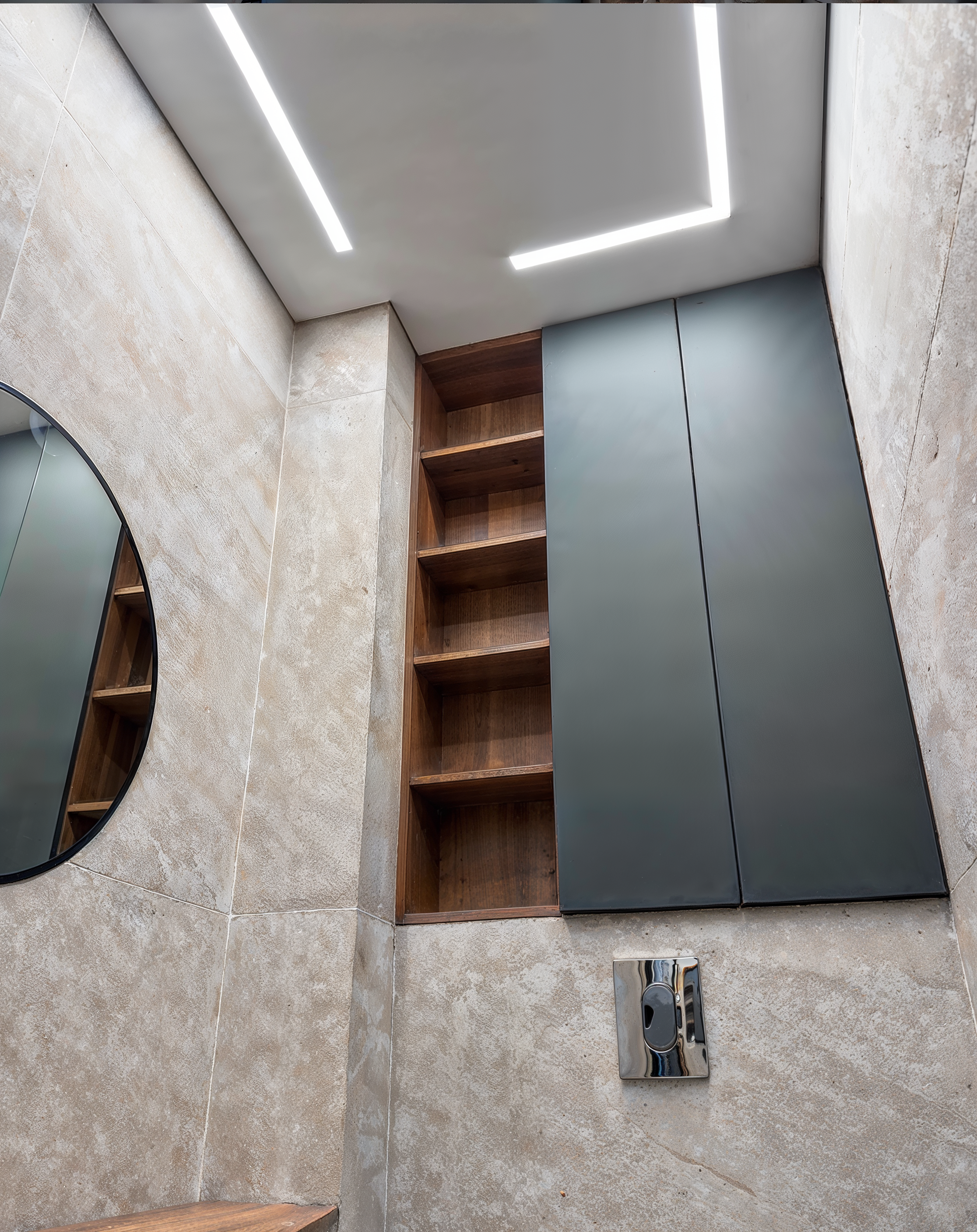 The light line continuing past a built-in wood shelving nook