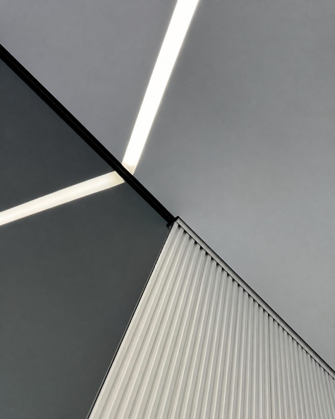 Where two light lines meet the edge of a slatted wood panel