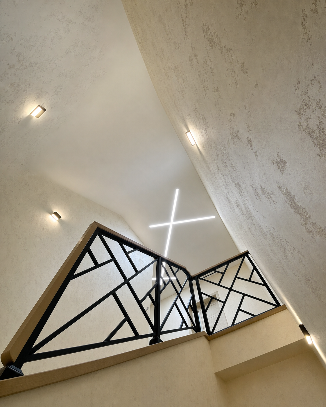 A closer view of the crossing lines above a geometric iron railing