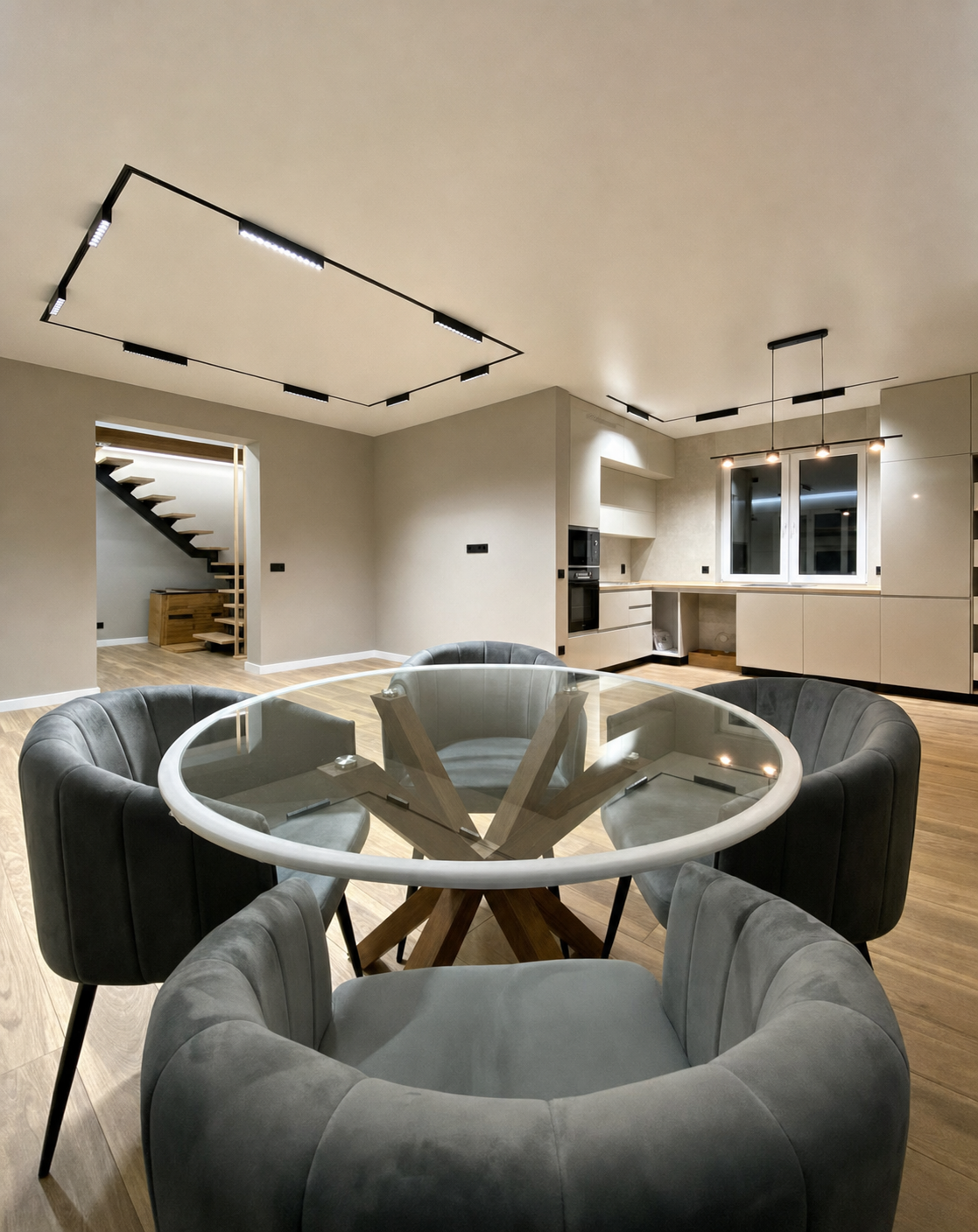 A rectangular track run with adjustable spotlights framing the dining table