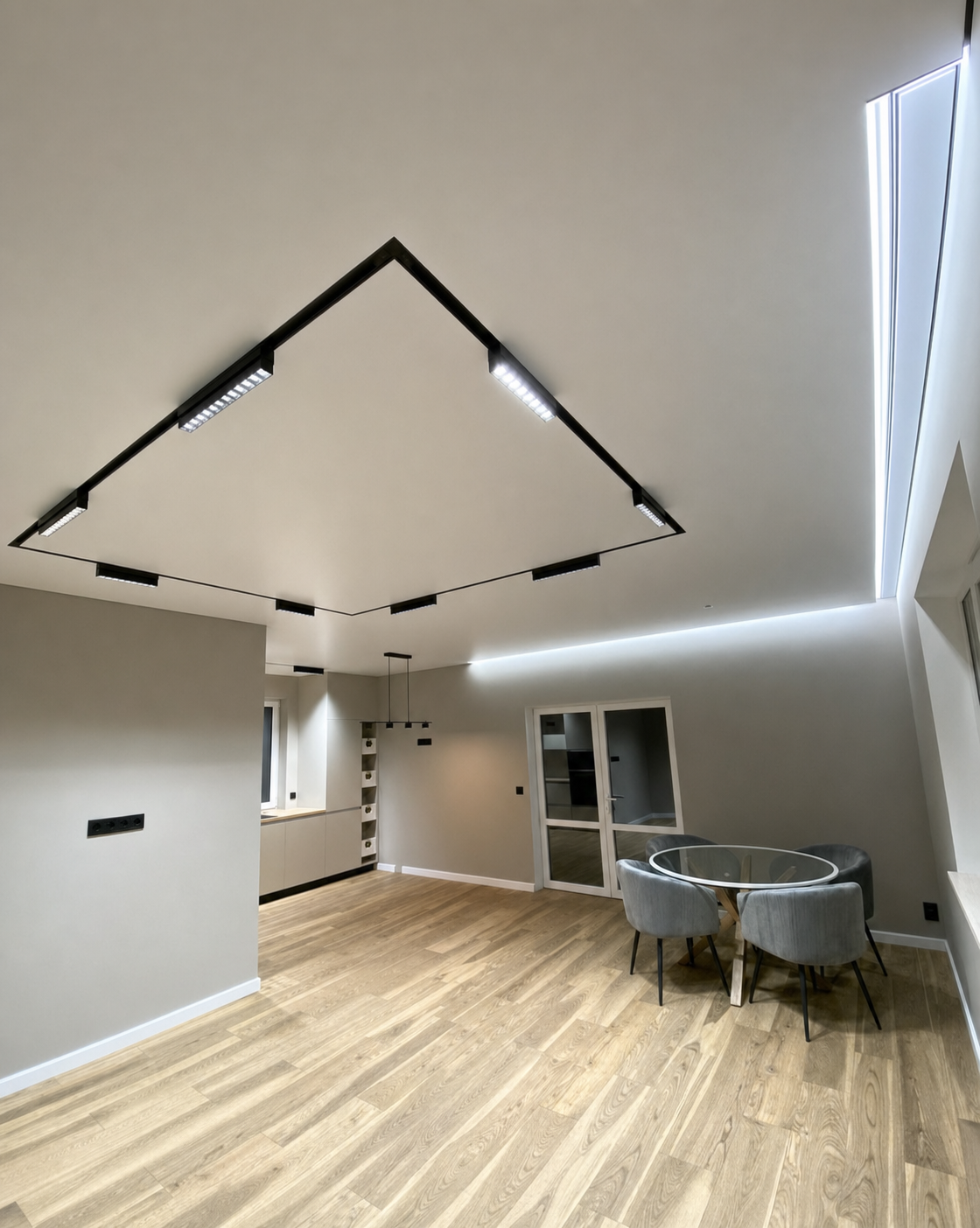 A triangular track run echoing the angled ceiling and skylight