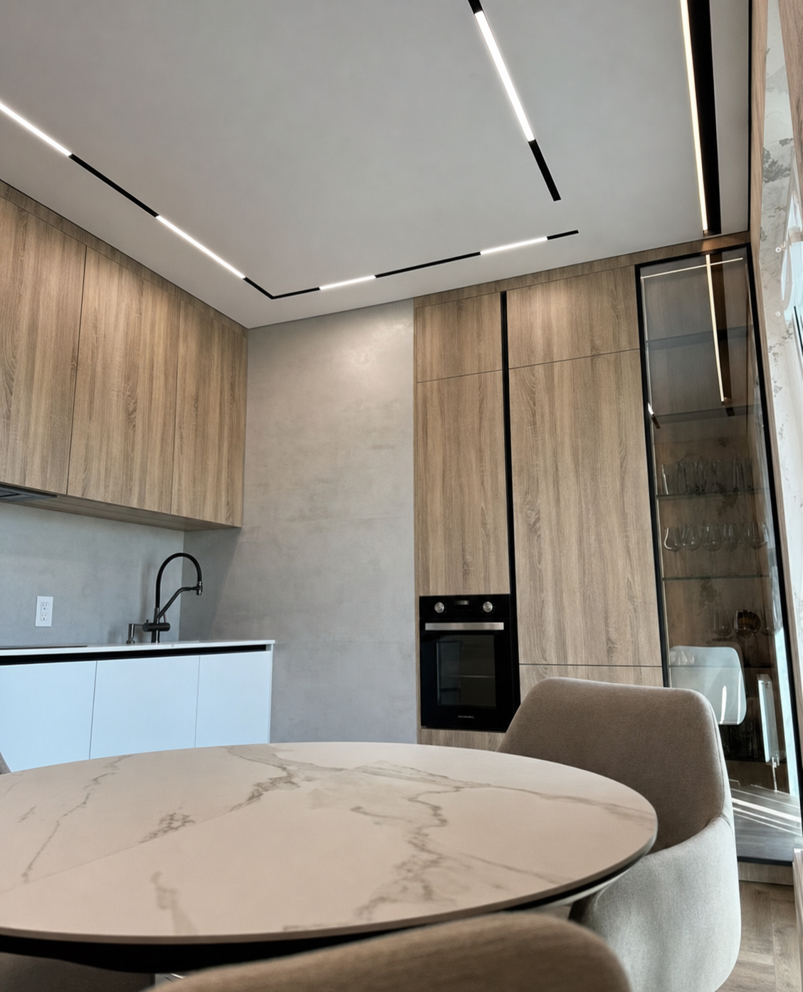 The full kitchen and dining nook under the angled light channel