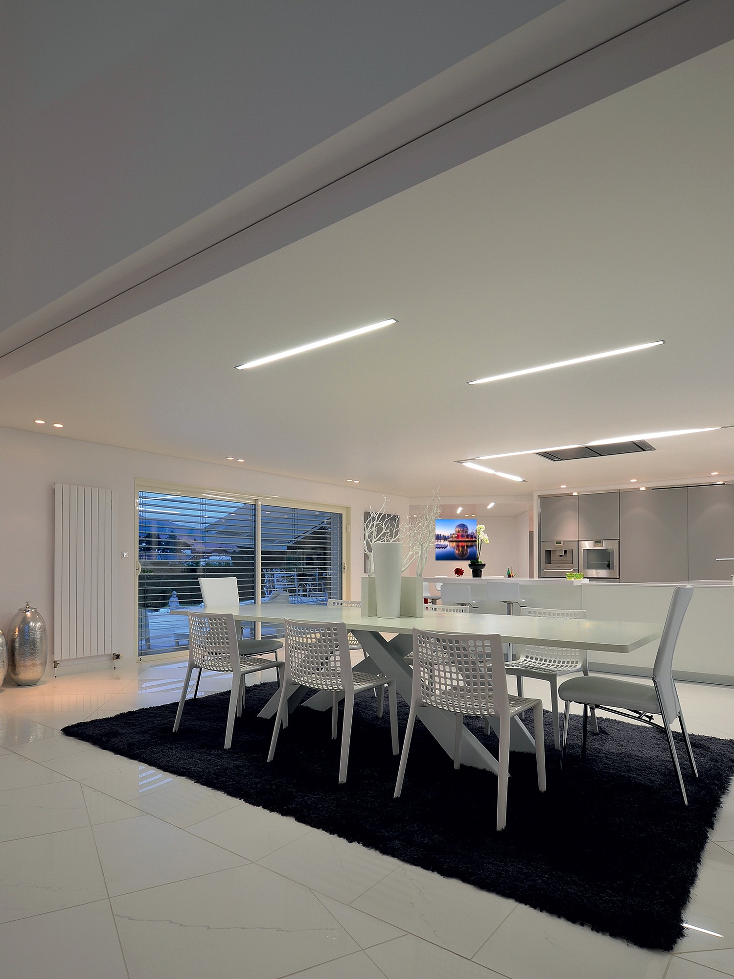 Modern kitchen with a gloss stretch ceiling and LED light lines in Vancouver